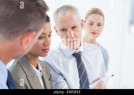 Businessman drawing graph on the board Stock Photo