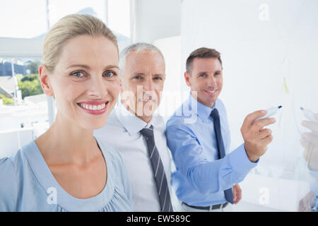 Businessman drawing graph on the board Stock Photo