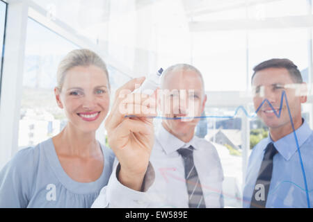 Businessman drawing graph on the glass Stock Photo