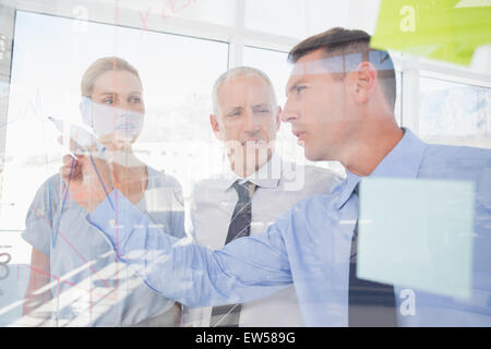 Businessman drawing graph on the glass Stock Photo