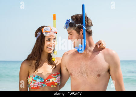 happy couple smiling at each other with mask and snorkel Stock Photo