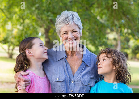 Extended family smiling and kissing in a park Stock Photo