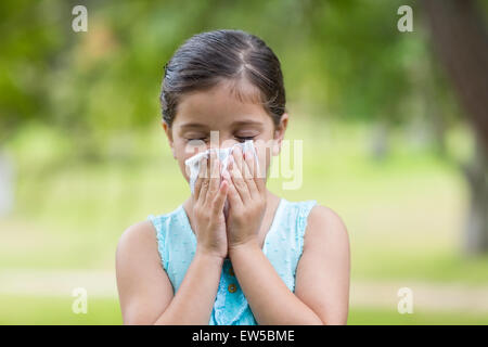 Little girl blowing his nose Stock Photo