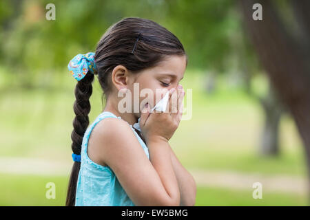 Little girl blowing his nose Stock Photo