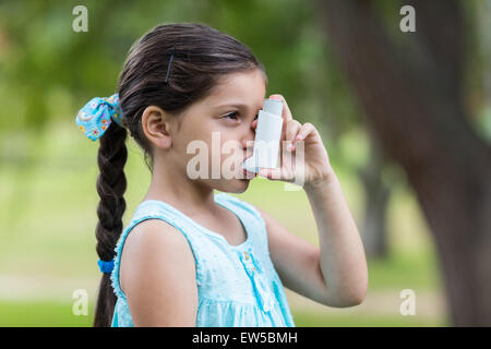 Little girl using his inhaler Stock Photo