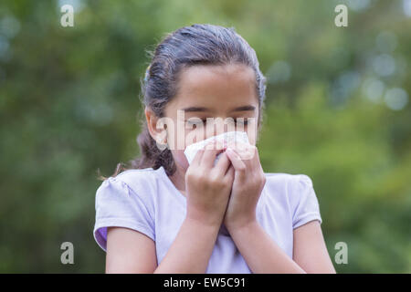 Little girl blowing his nose Stock Photo