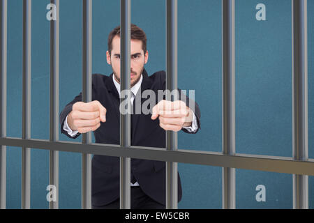 Composite image of angry businessman standing with clenched fists Stock Photo