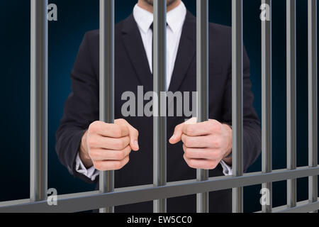 Composite image of elegant businessman in suit clenching his fists Stock Photo