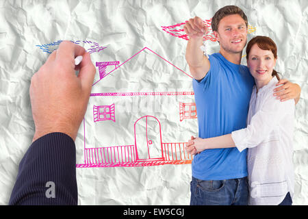 Composite image of couple holding keys to home Stock Photo