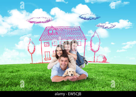 Composite image of happy family lying on top of each other with dog Stock Photo