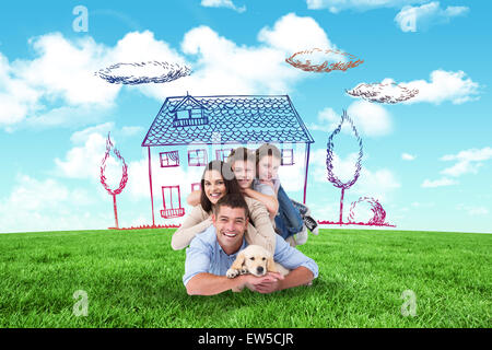 Composite image of happy family lying on top of each other with dog Stock Photo