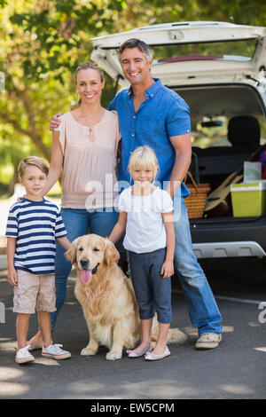 Happy family with their dog in the park Stock Photo