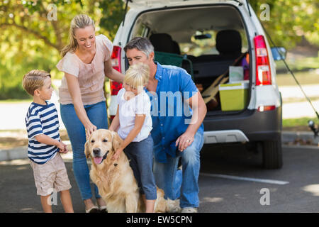 Happy family with their dog in the park Stock Photo