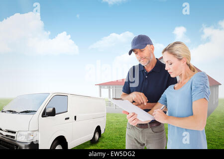 Composite image of happy blonde signing for a delivery Stock Photo