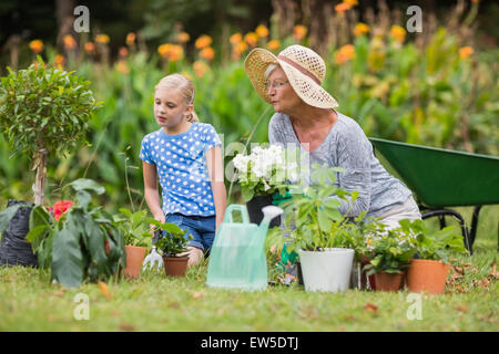 Happy grandmother with her granddaughter gardening Stock Photo