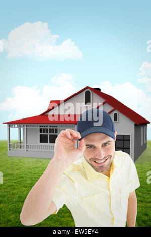 Composite image of handsome delivery man wearing baseball cap Stock Photo