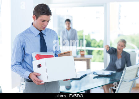 Businessman carrying his belongings in box Stock Photo