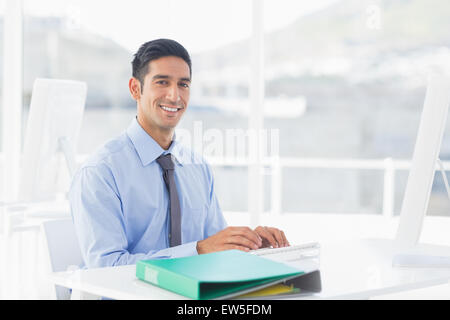 Smiling businessman using computer Stock Photo