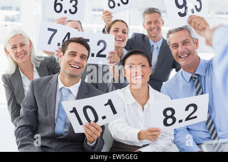 Interview panel holding score cards in office Stock Photo
