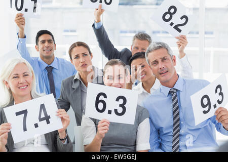 Interview panel holding score cards in office Stock Photo