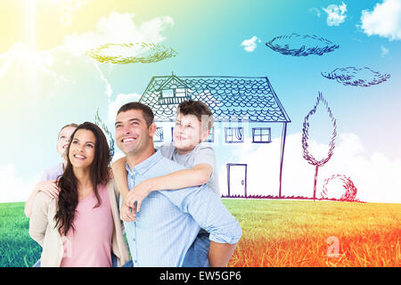 Composite image of happy parents giving piggyback ride to children while looking up Stock Photo