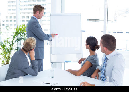 Manager presenting whiteboard to his colleagues Stock Photo