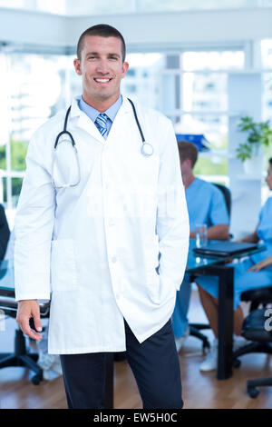 Handsome smiling doctor looking at camera Stock Photo