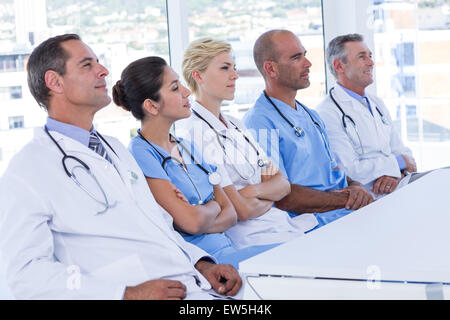 Team of doctors listening during meeting Stock Photo