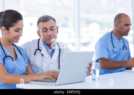 Doctors using computer Stock Photo