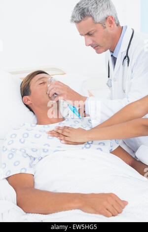 Doctor putting an oxygen mask Stock Photo