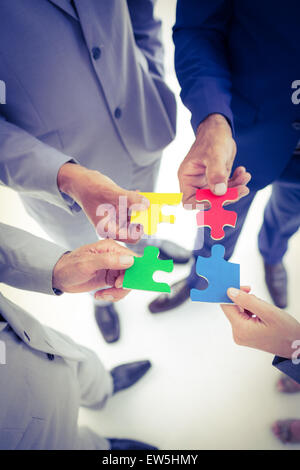 Problem solving and partnership, man and woman connecting two puzzle ...