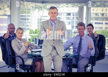Business team showing thumbs up Stock Photo
