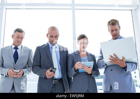 Business colleagues using their multimedia devices Stock Photo