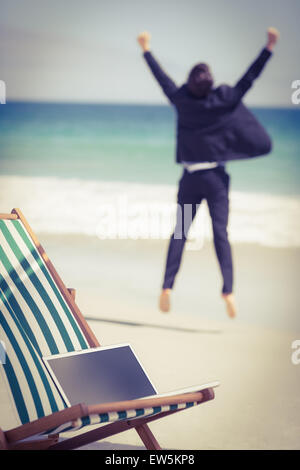 Excited businessman wearing suit jumping Stock Photo