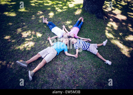 Happy familly lying down in the park Stock Photo