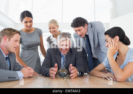 Businessman forecasting the future with his crystal ball Stock Photo