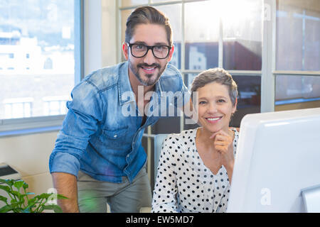 Smiling colleagues looking at camera Stock Photo