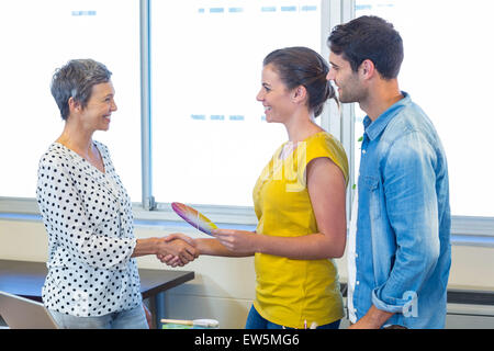 Casual businesswomen shaking hands Stock Photo