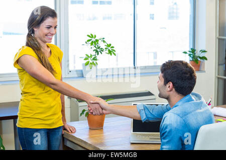 Casual business partners shaking their hands Stock Photo