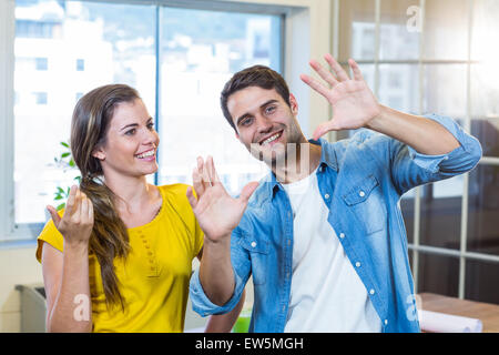 Handsome businessman doing frame with his hands and showing to his partner Stock Photo