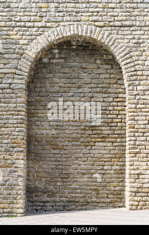 Medieval limestone wall with arch Stock Photo