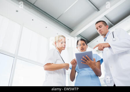 Doctors looking together at tablet Stock Photo