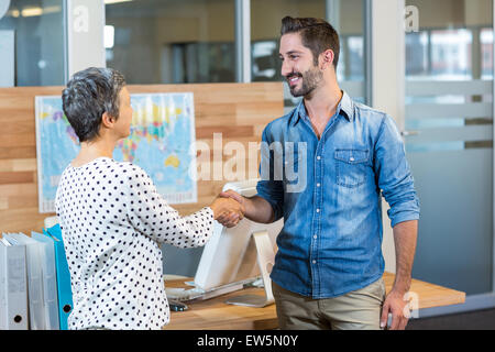 Smiling business people shaking hands Stock Photo