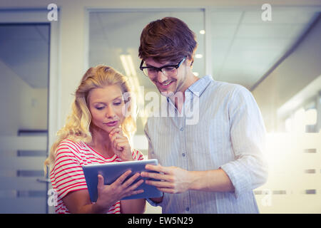 Colleagues looking at tablet pc together Stock Photo