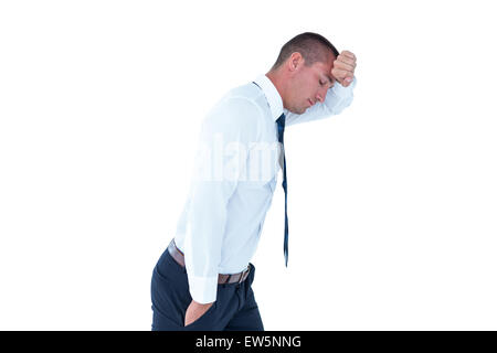 Worried businessman leaning on wall Stock Photo