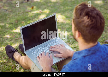 Young man using laptop in the park Stock Photo