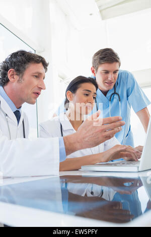 Team of doctors working on laptop computer Stock Photo