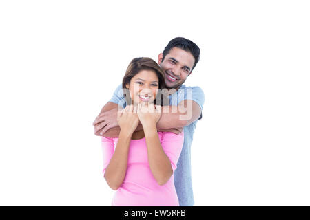 Happy couple embracing and looking at the camera Stock Photo