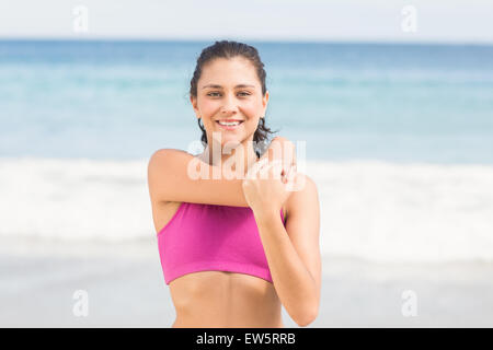 Pretty woman stretching her arm Stock Photo