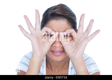Pretty brunette making glasses with her hands Stock Photo